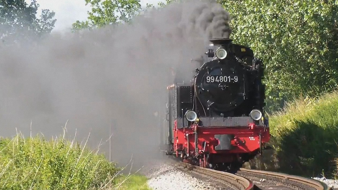 A steam locomotive coming towards the photographer.